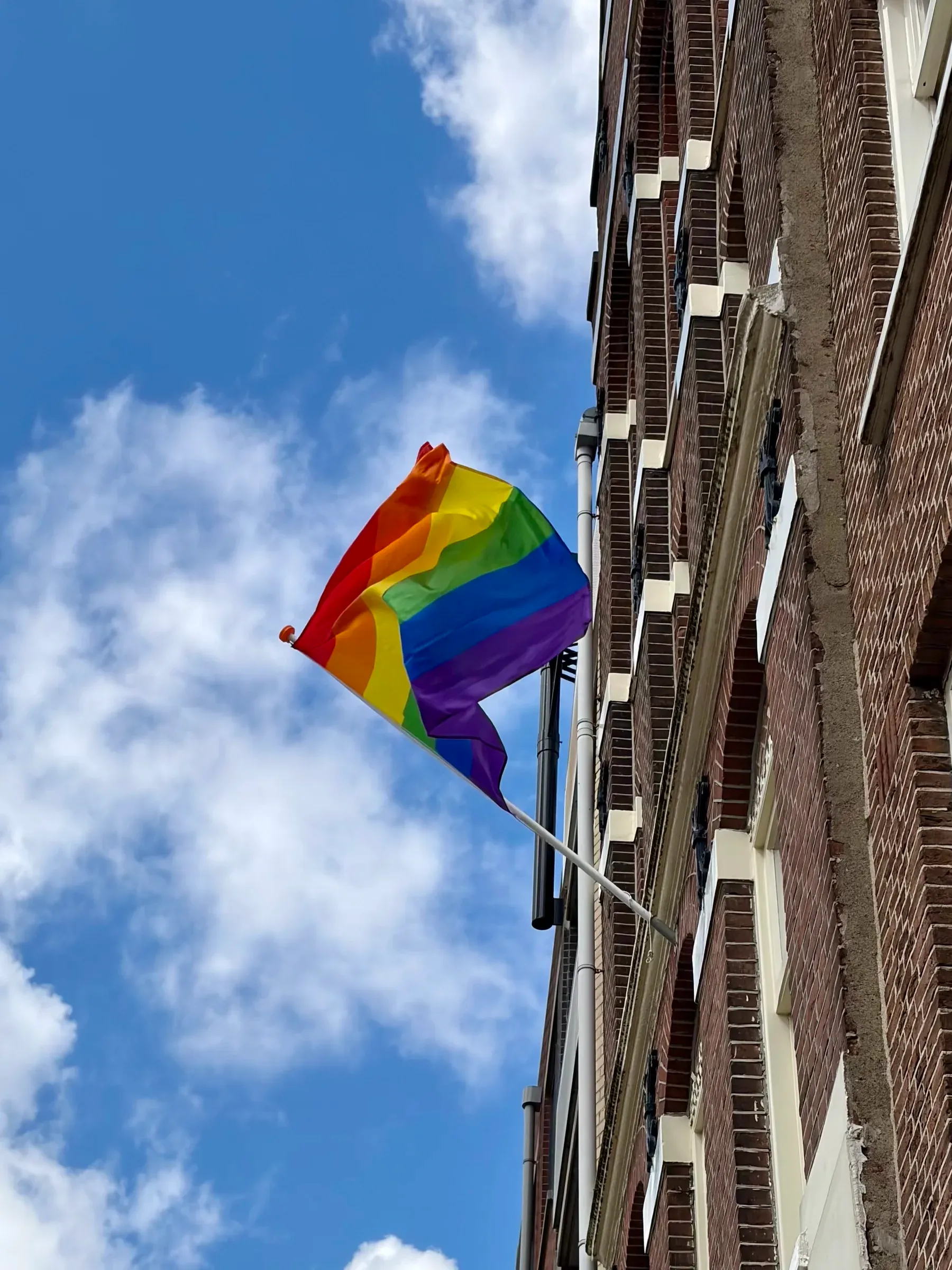 Rainbow flag above an Amsterdam street