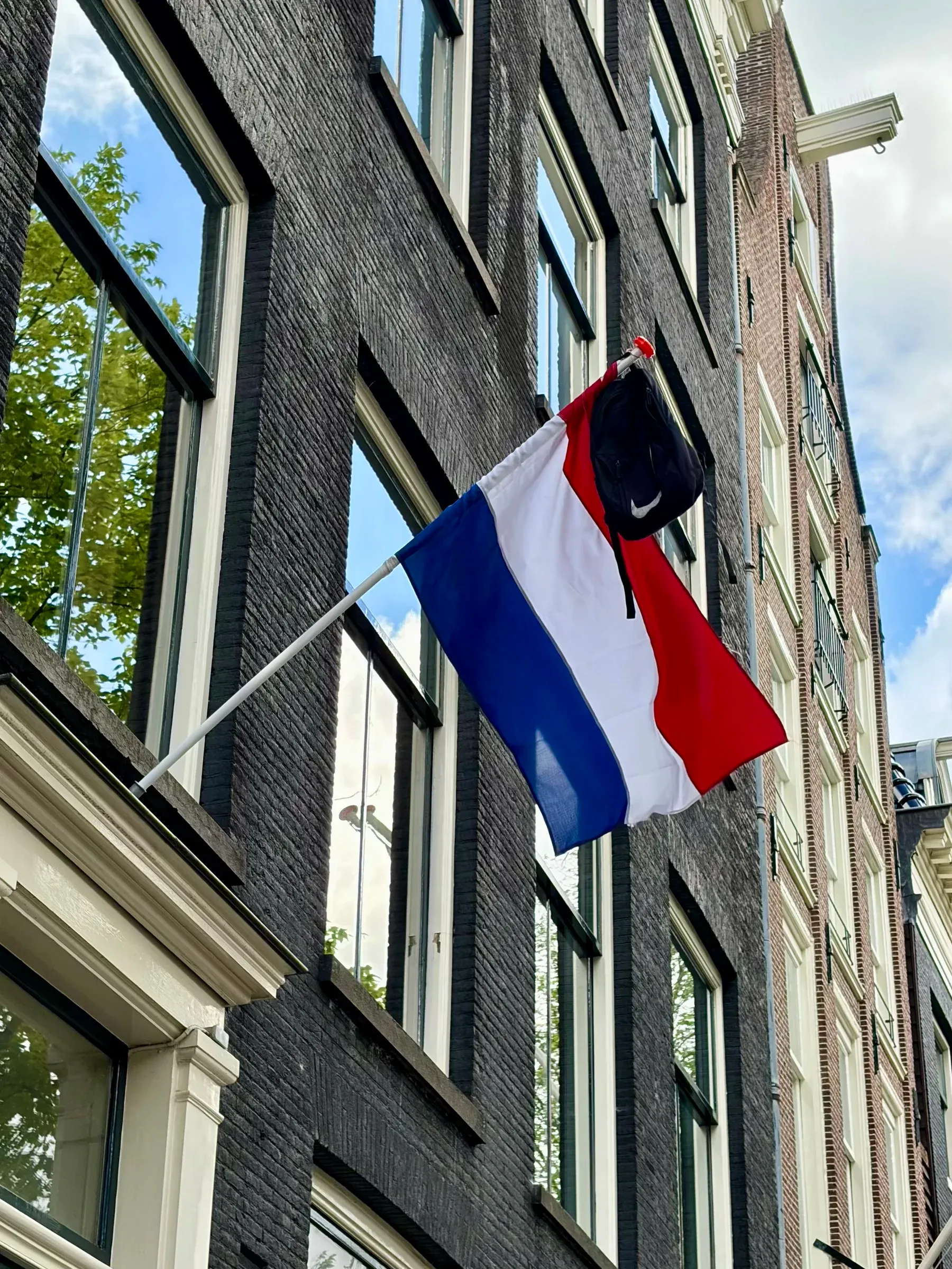 Dutch flag and school bag marking graduation tradition in Amsterdam