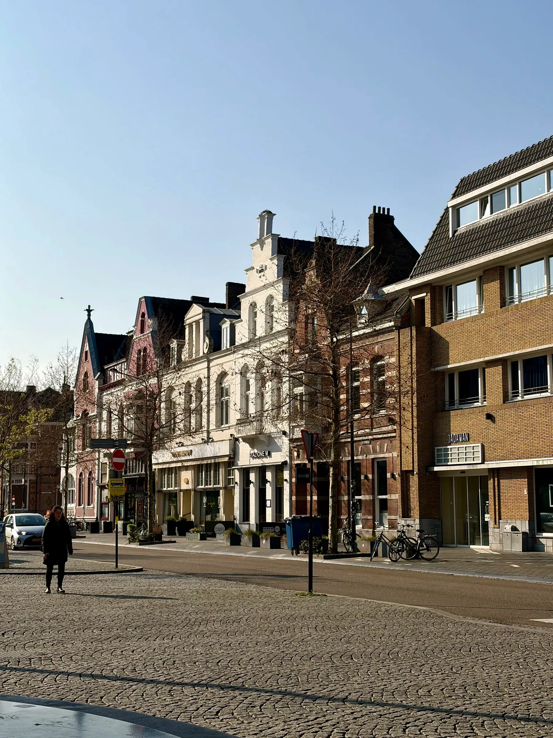 Sunlit street facades in Wyck near Maastricht station