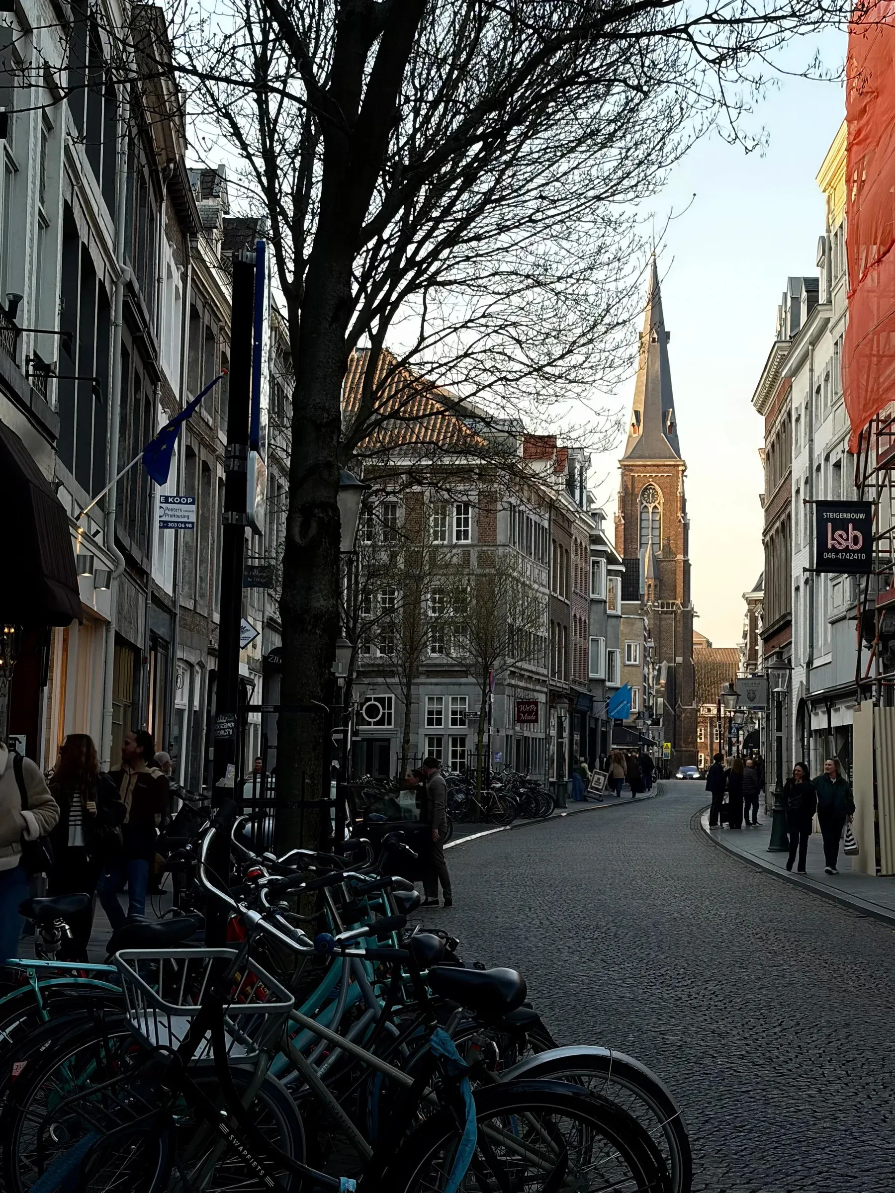 Low sun at the end of a cobbled Maastricht street