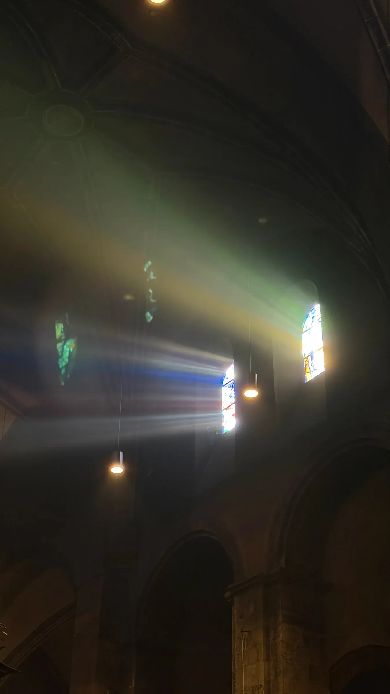 Sunbeam cutting through stained glass inside the Basilica of Our Lady