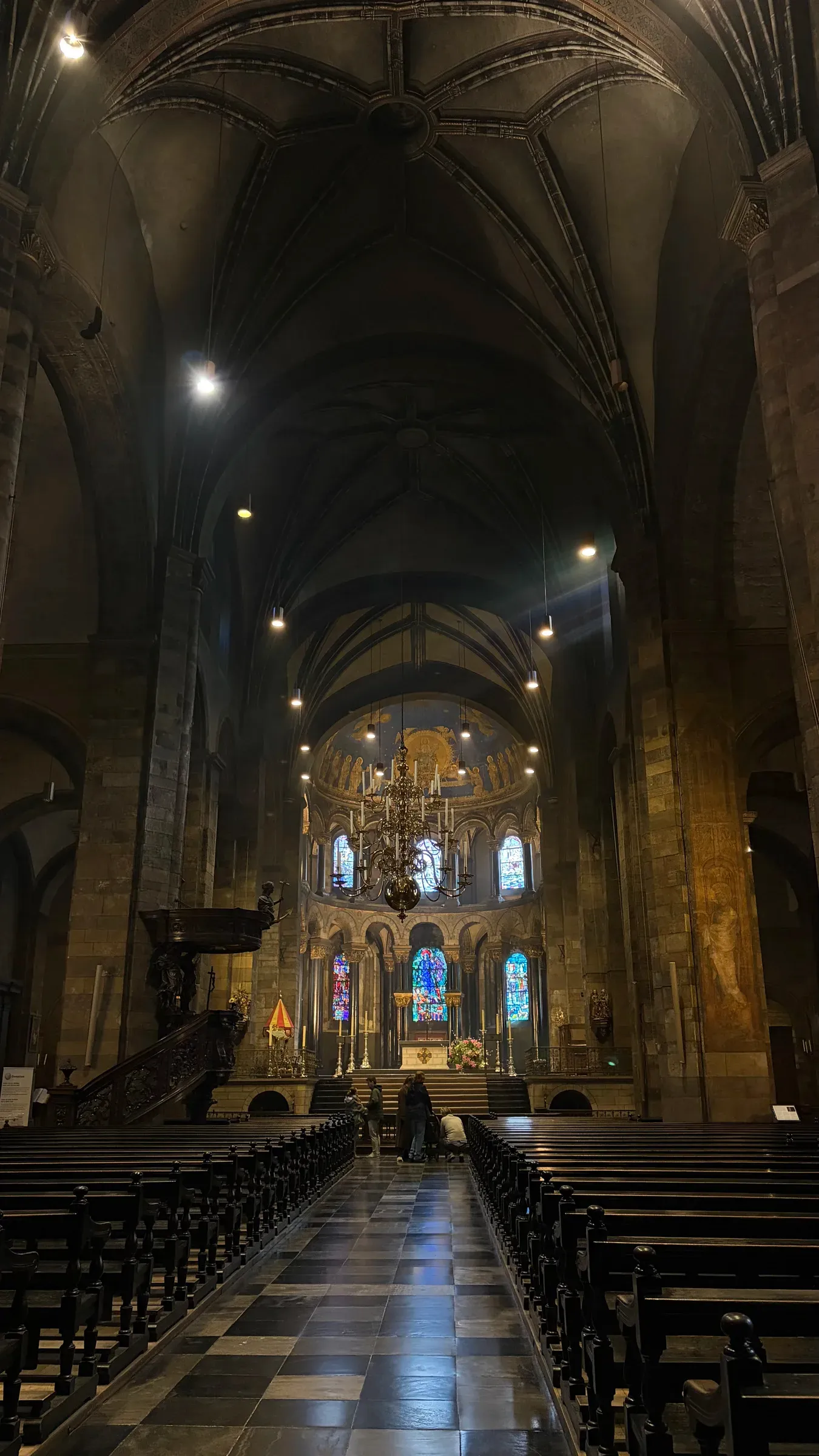 Central nave and illuminated altar inside the Basilica of Our Lady