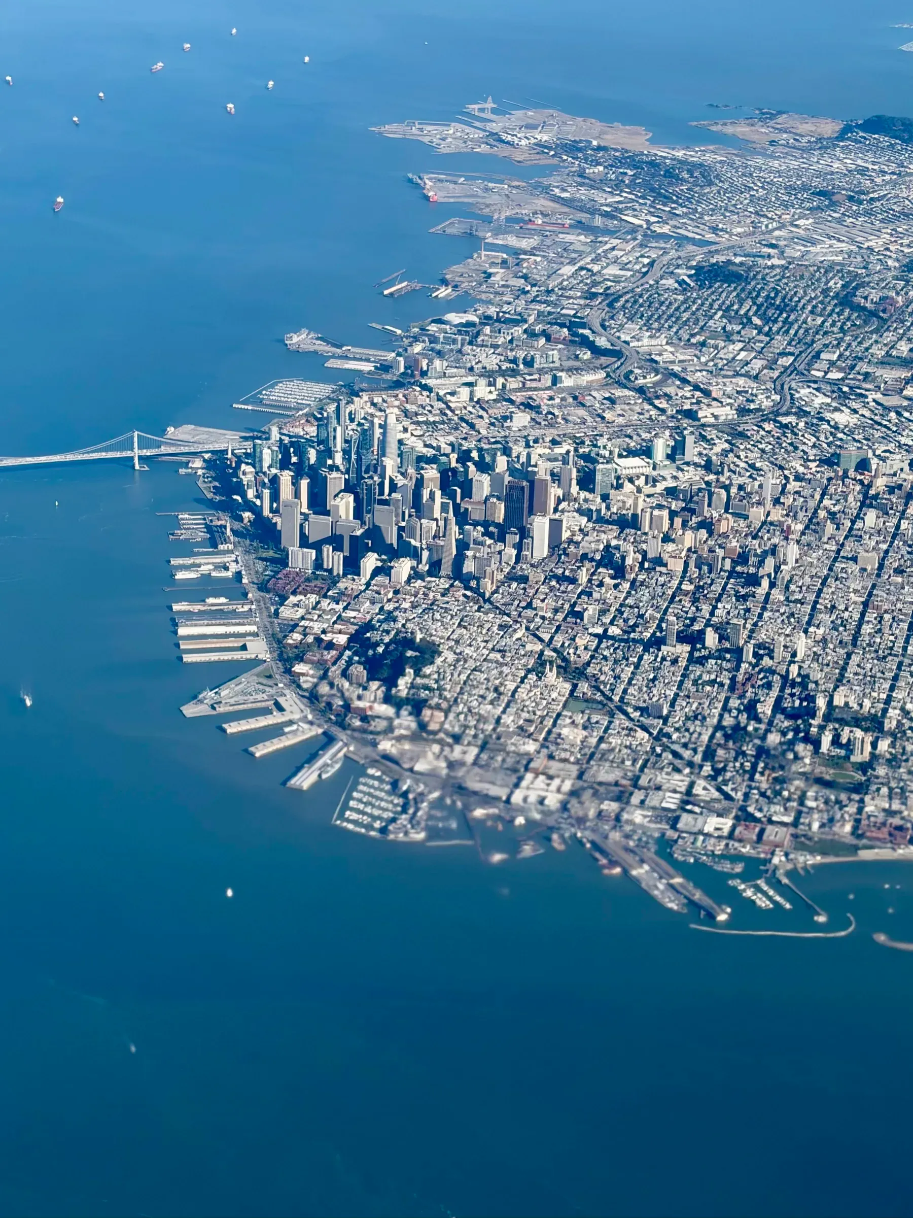 Aerial view of downtown San Francisco, the Embarcadero piers, and the Bay Bridge