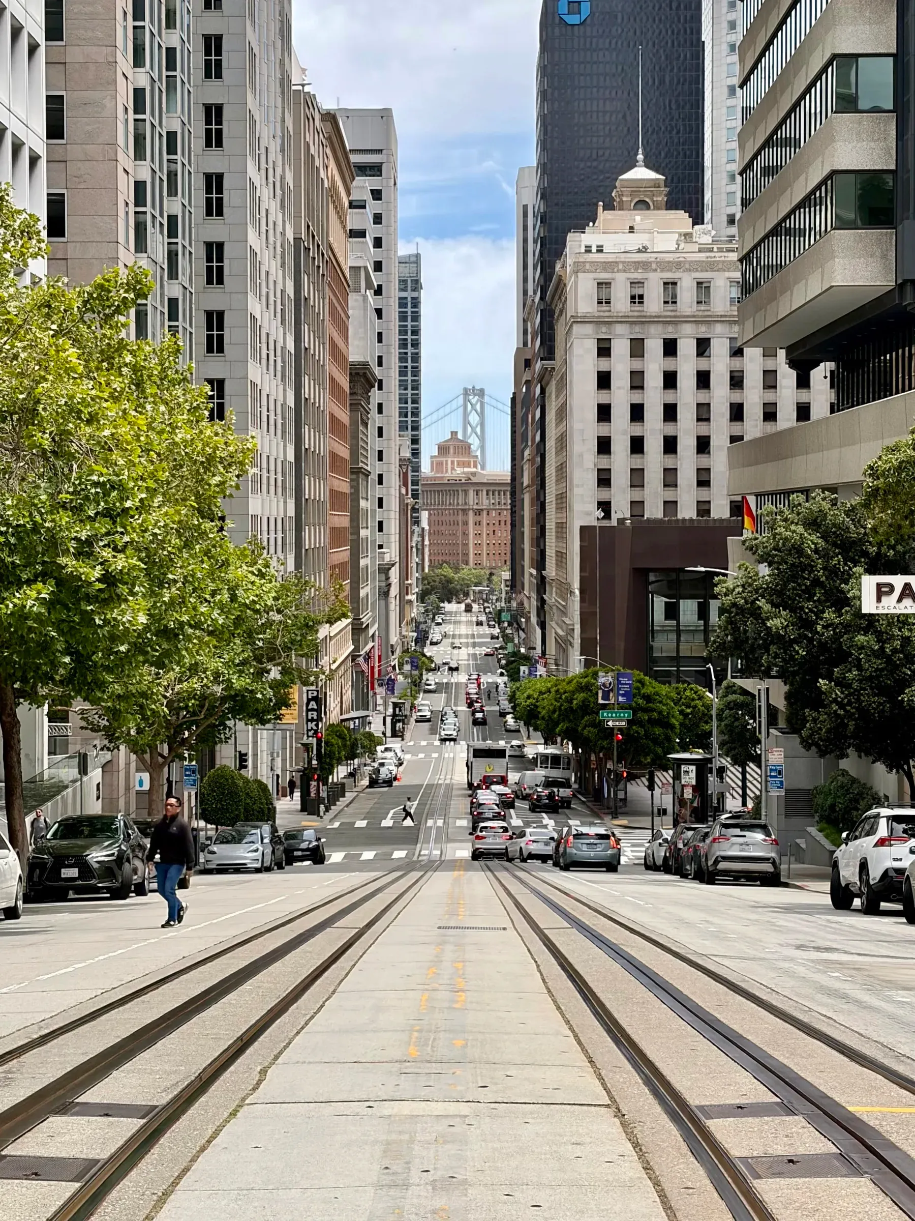 California Street cable car tracks descending Nob Hill between downtown skyscrapers
