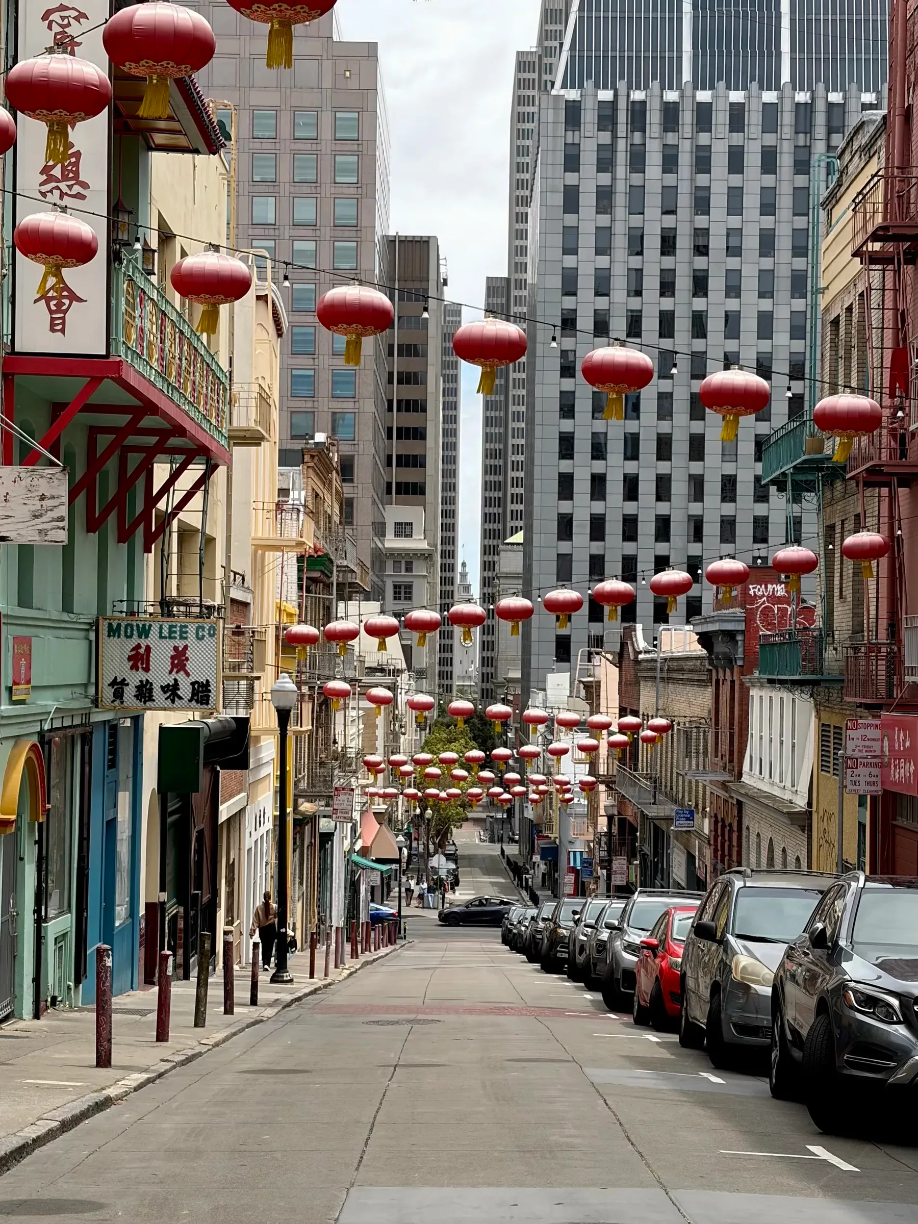 Brightly painted corner building with decorative lanterns in Chinatown