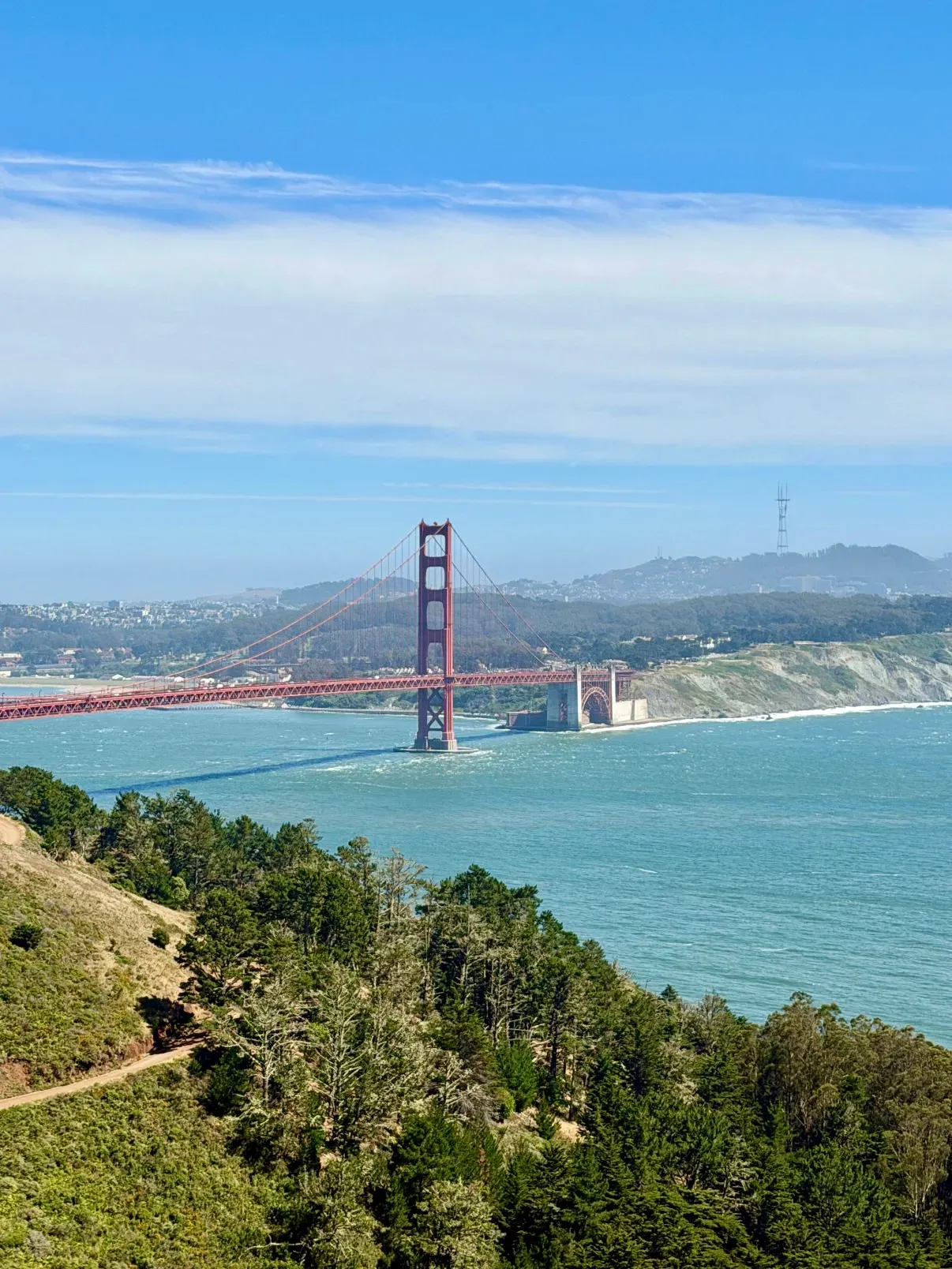 Distant Golden Gate Bridge span under clear June sky