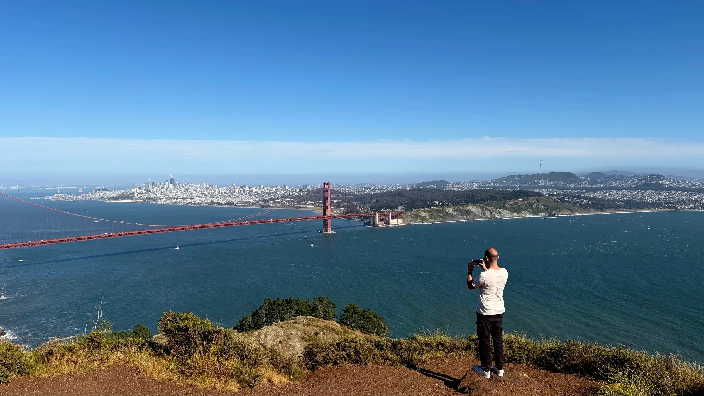 Golden Gate Bridge towers and Marin Headlands cliffs soaring above the Pacific ocean entry