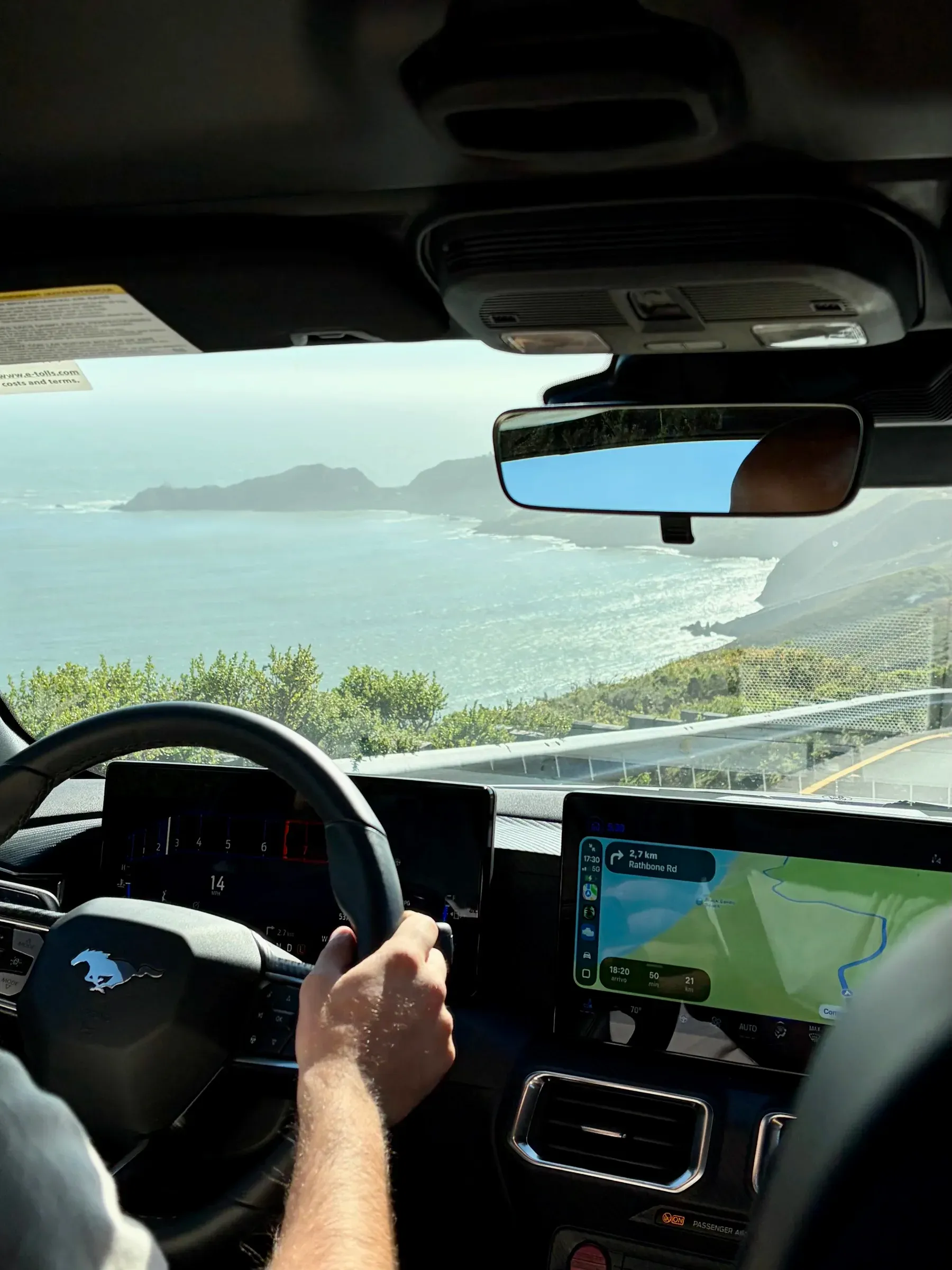 Ford Mustang rear-view mirror framing the Golden Gate Headlands
