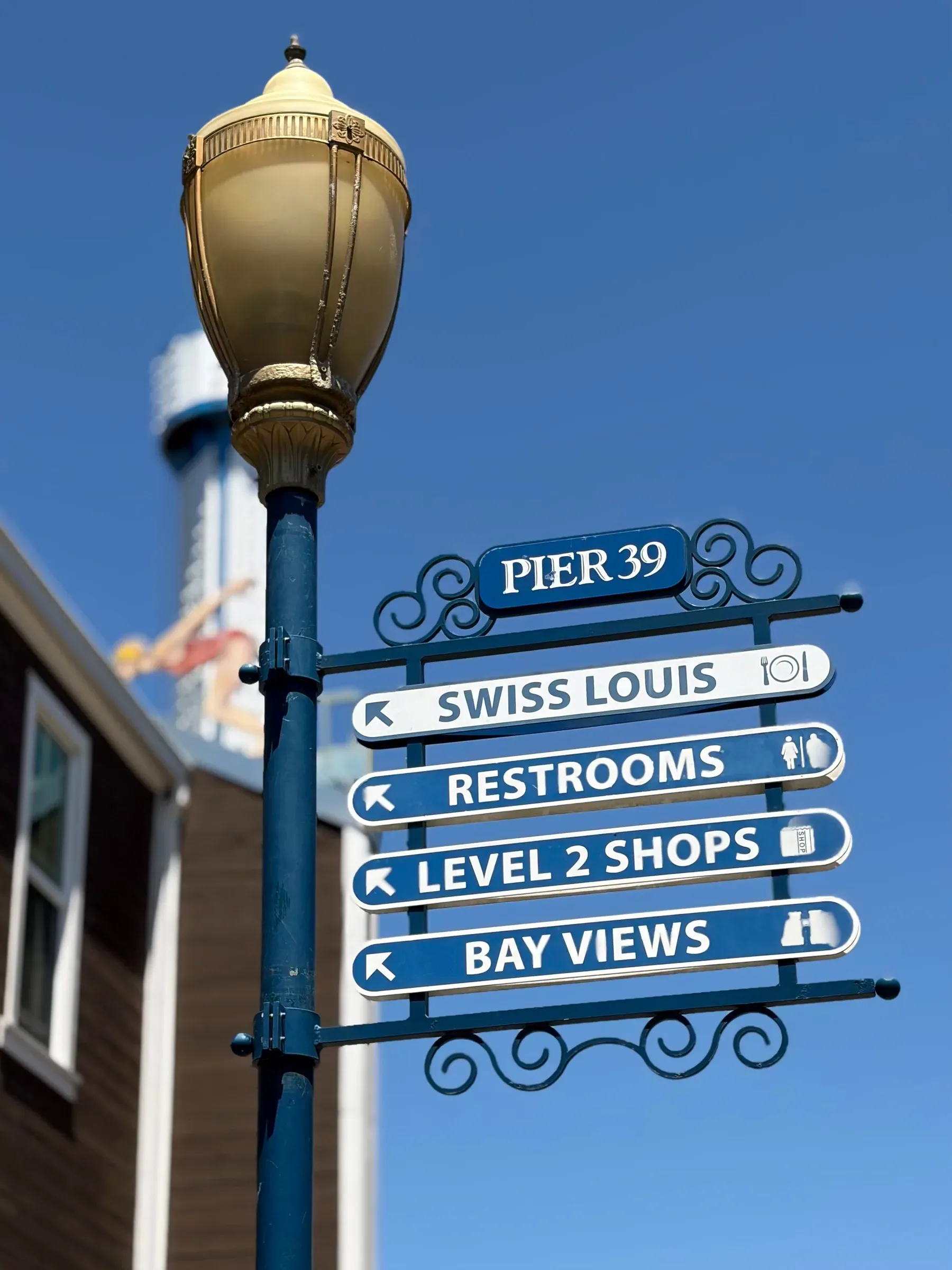 Vintage directional wooden signpost and lamp post at Pier 39