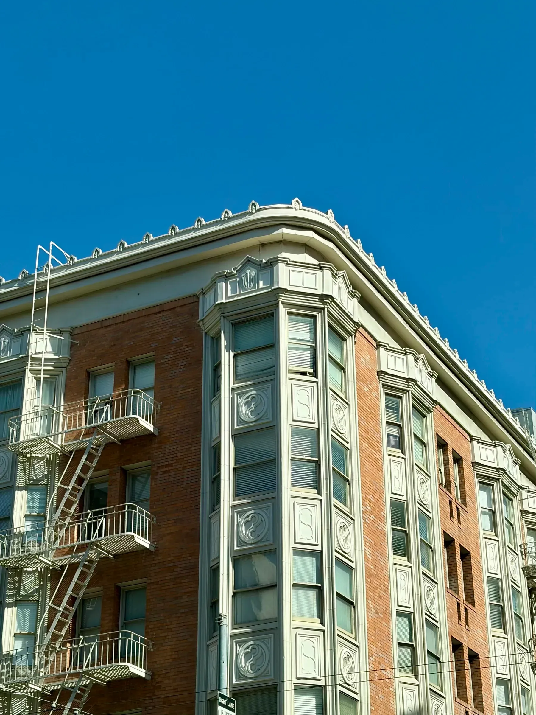 Downtown street corner contrasting vintage masonry facades with modern glass towers