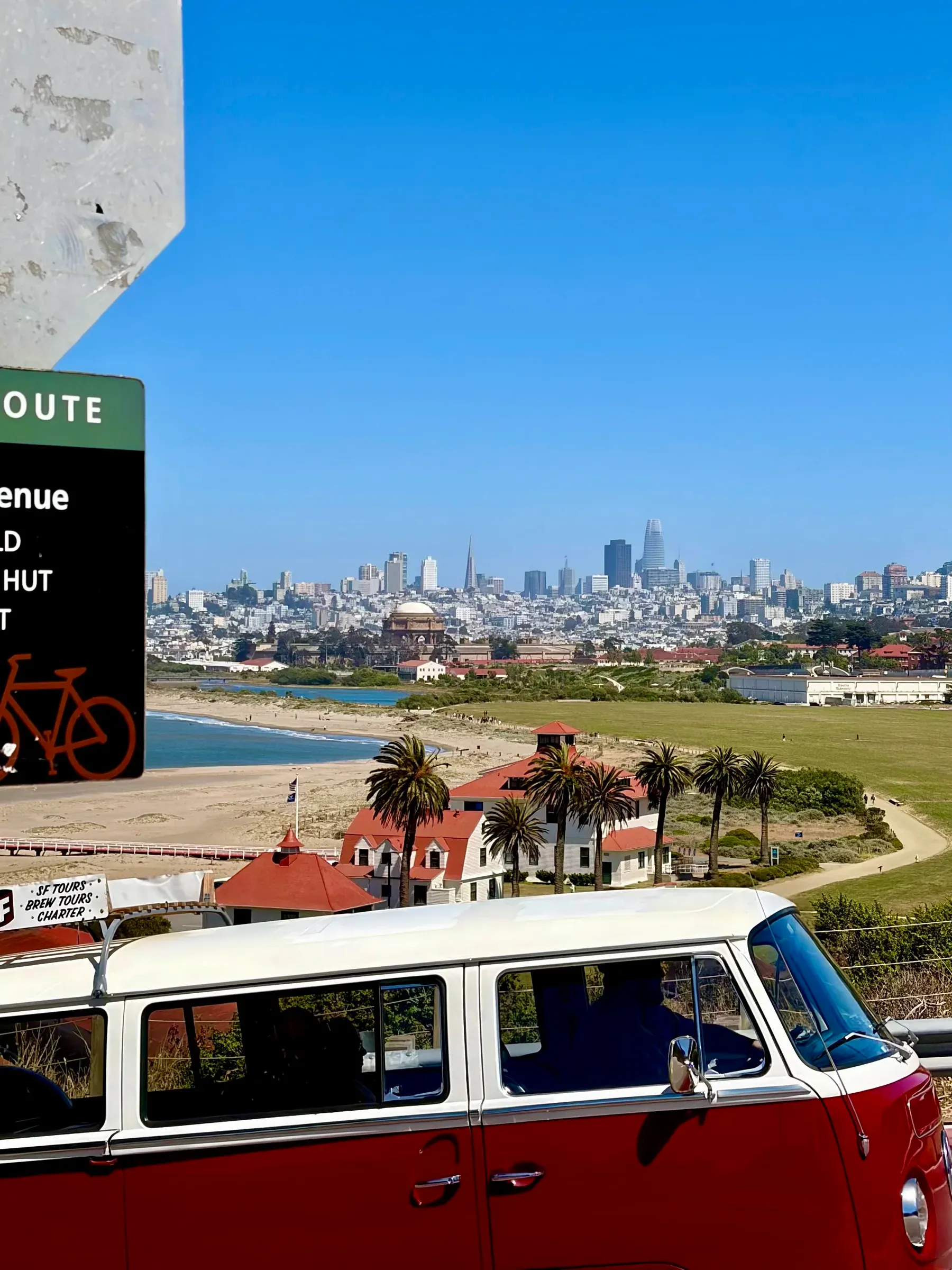 Vintage blue Volkswagen Bus parked at Crissy Field with downtown San Francisco skyline behind