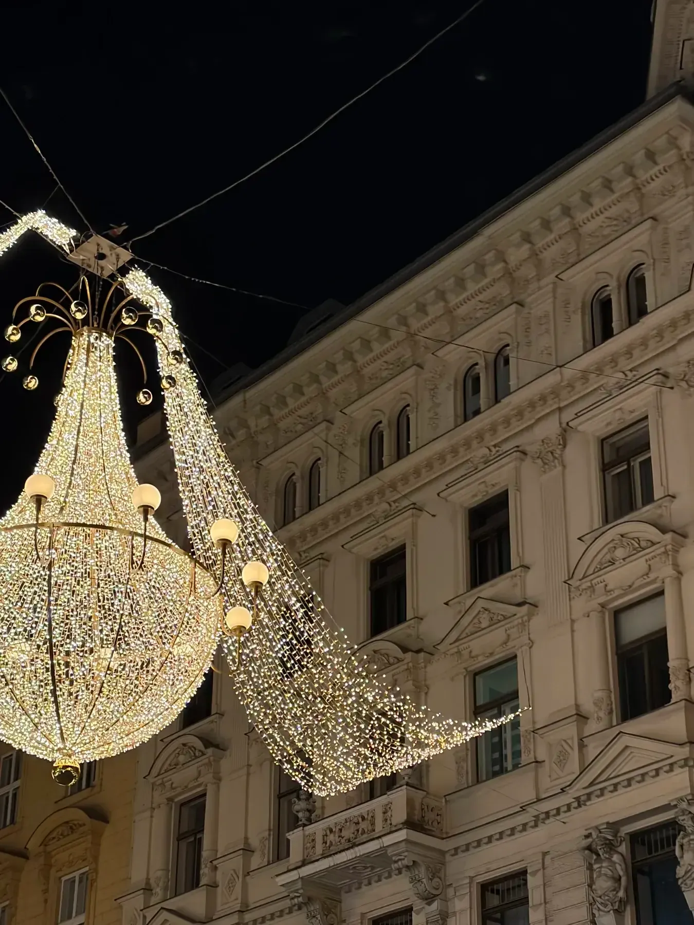 Chandelier Christmas light suspended beside a Vienna building facade