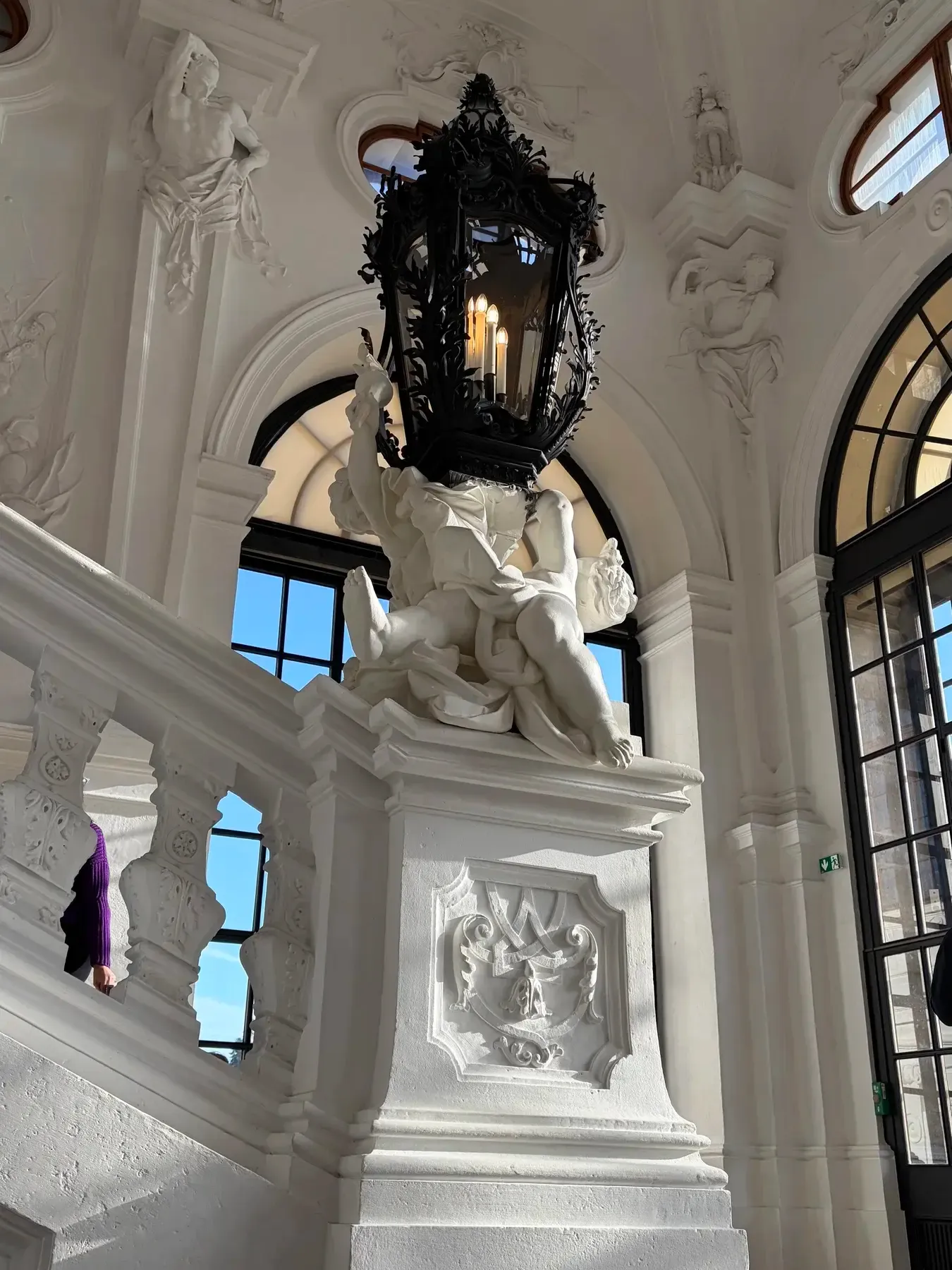 White baroque staircase sculpture and lantern inside the Belvedere