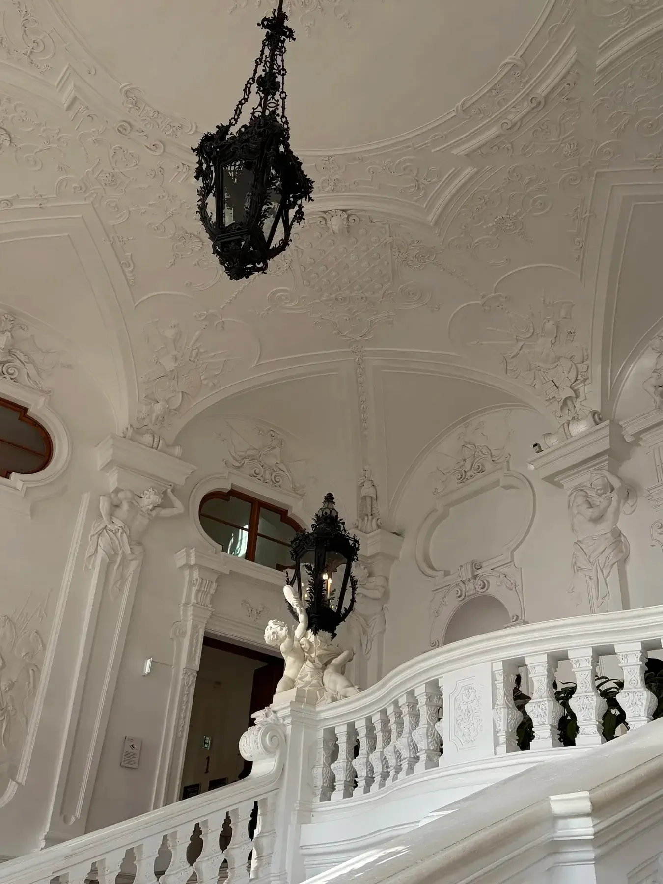 White staircase and chandelier inside the Belvedere