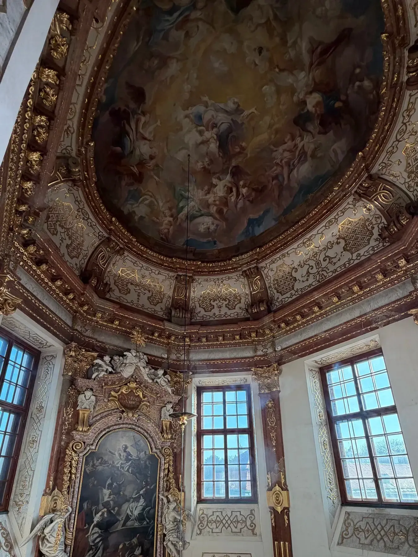 Painted ceiling and tall windows inside the Belvedere