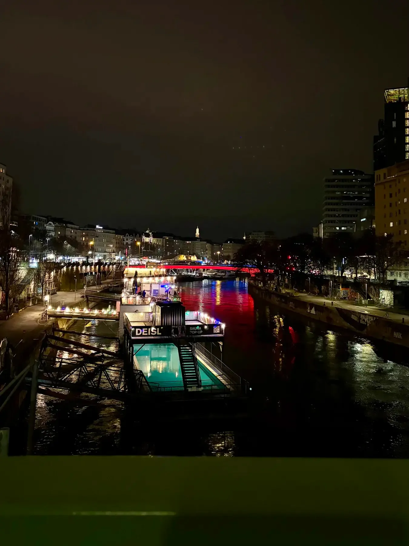 Floating pool boat and bridge lights on the Donaukanal