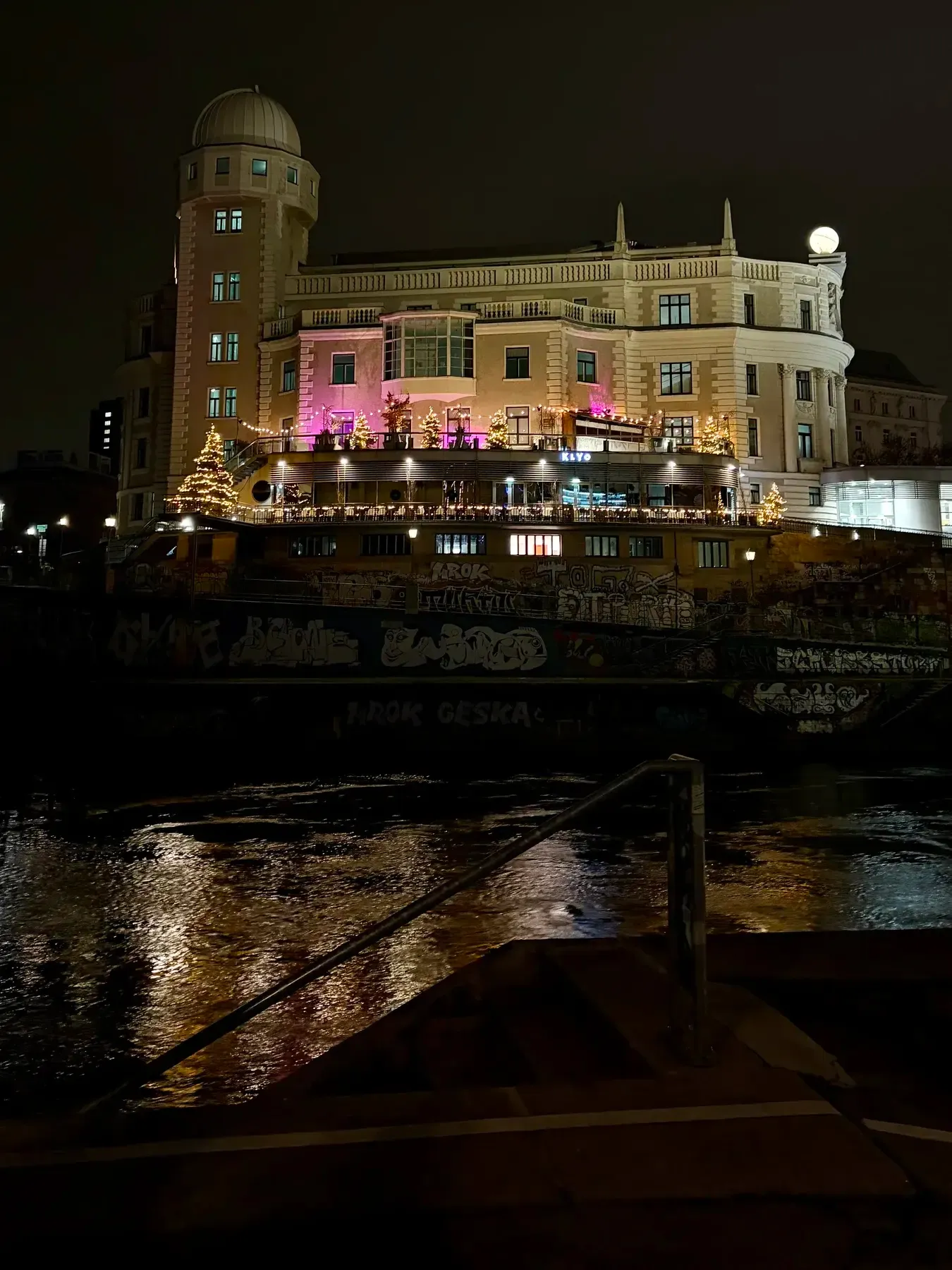 Urania building reflected in the Donaukanal at night