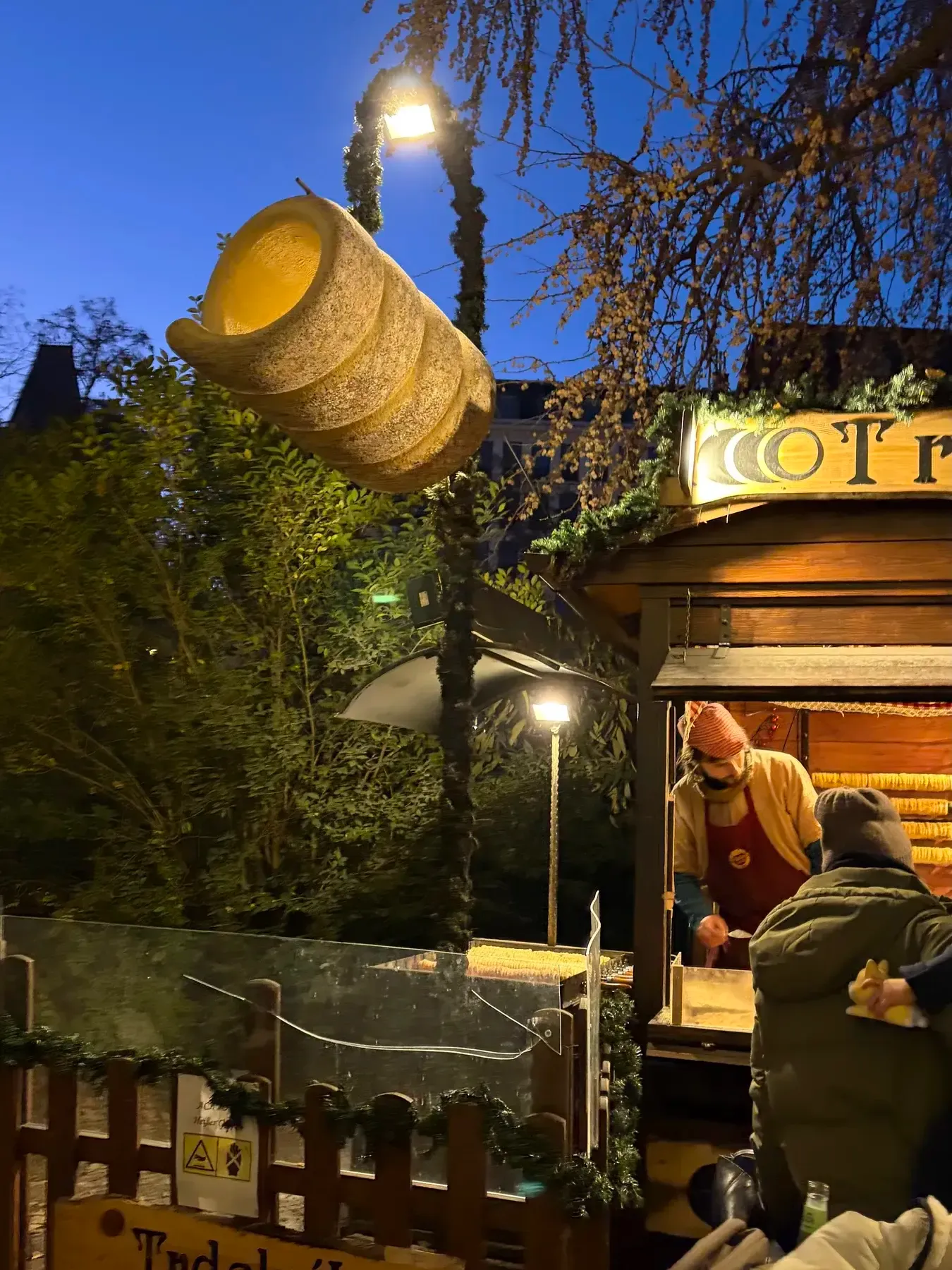 Trdelnik stall with a hanging pastry model at Rathausplatz